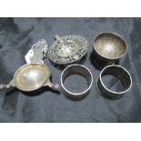 Five pieces of Middle Eastern/Chinese silver including a salt, two tea strainers and pair of