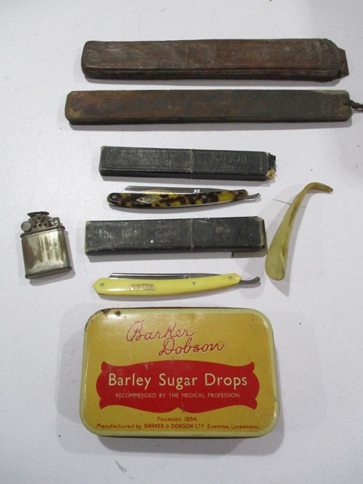 Two cut throat razors, strop, lighter, tin etc.