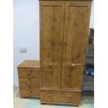 A pine wardrobe with a matching bedside cabinet