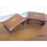 A pair of inlaid footstools