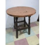 A copper topped round pub table