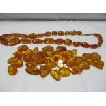 An amber necklace with an amount of loose amber beads