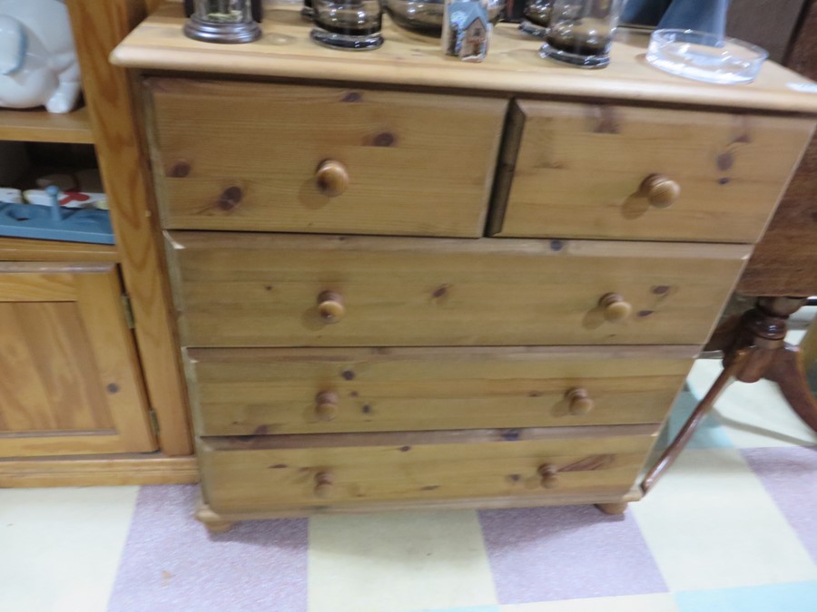 A pine chest of five drawers