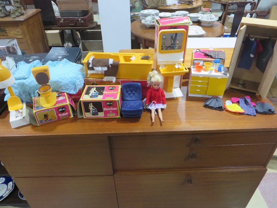 A vintage Sindy doll and collection of mainly boxed furniture including hair dryer, rocker, bed,