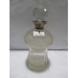 A cut glass decanter with silver mount