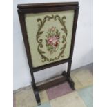 A Regency adjustable rosewood fire screen with later tapestry insert