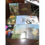 A small collection of records including Beatles Rubber Soul and Sgt Peppers, Dire straits, Eagles