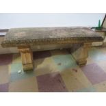 A concrete garden bench on two plinths