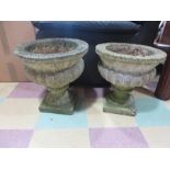 A pair of concrete garden urns