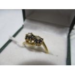 An 18ct gold ring set with diamonds and sapphires in two clusters