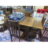 A draw leaf table and four chairs