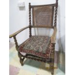 A cane seated oak armchair with carpet cushion A/F