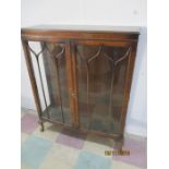 A bow fronted display cabinet