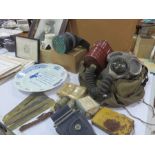 A collection of militaria items including gas masks, ointments, dressing , magazines, cigarette