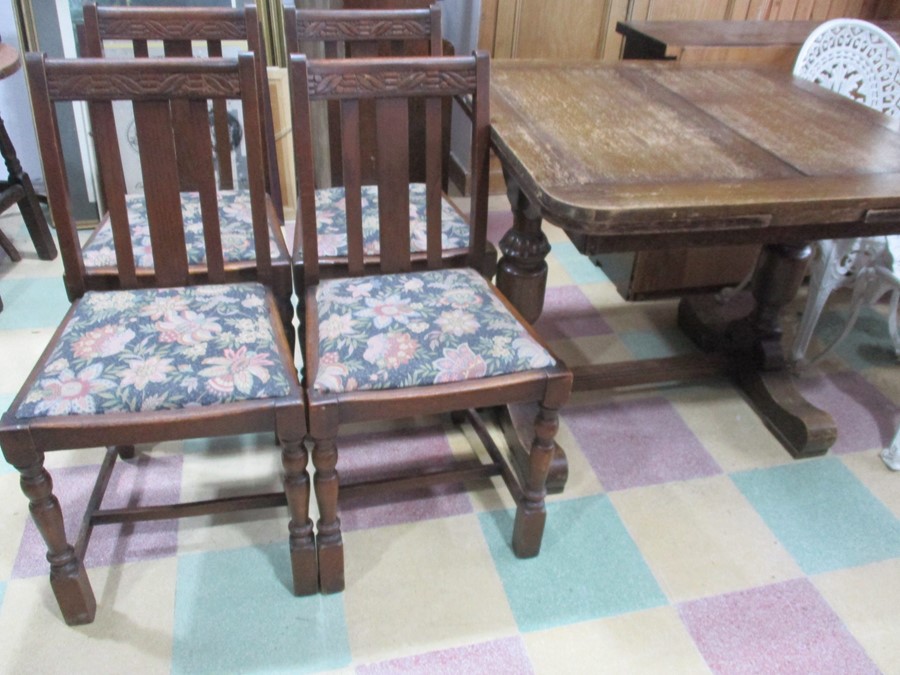 An oak drawleaf table and four chairs