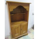A pine cupboard with shelves over