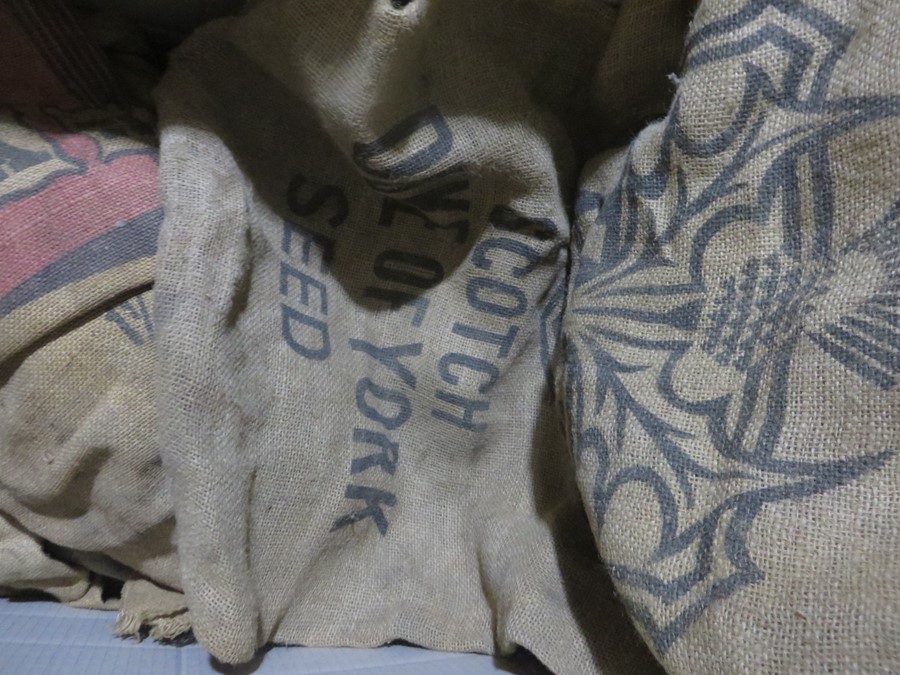 A large collection of burlap sacks, mainly advertising