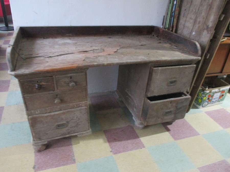 A distressed pine kneehole desk/ counter