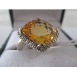 A cushion cut Citrine and diamond ring set in 18ct white gold, the centre stone approx 5-6 carats