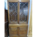 An oak display cabinet with cupboard under
