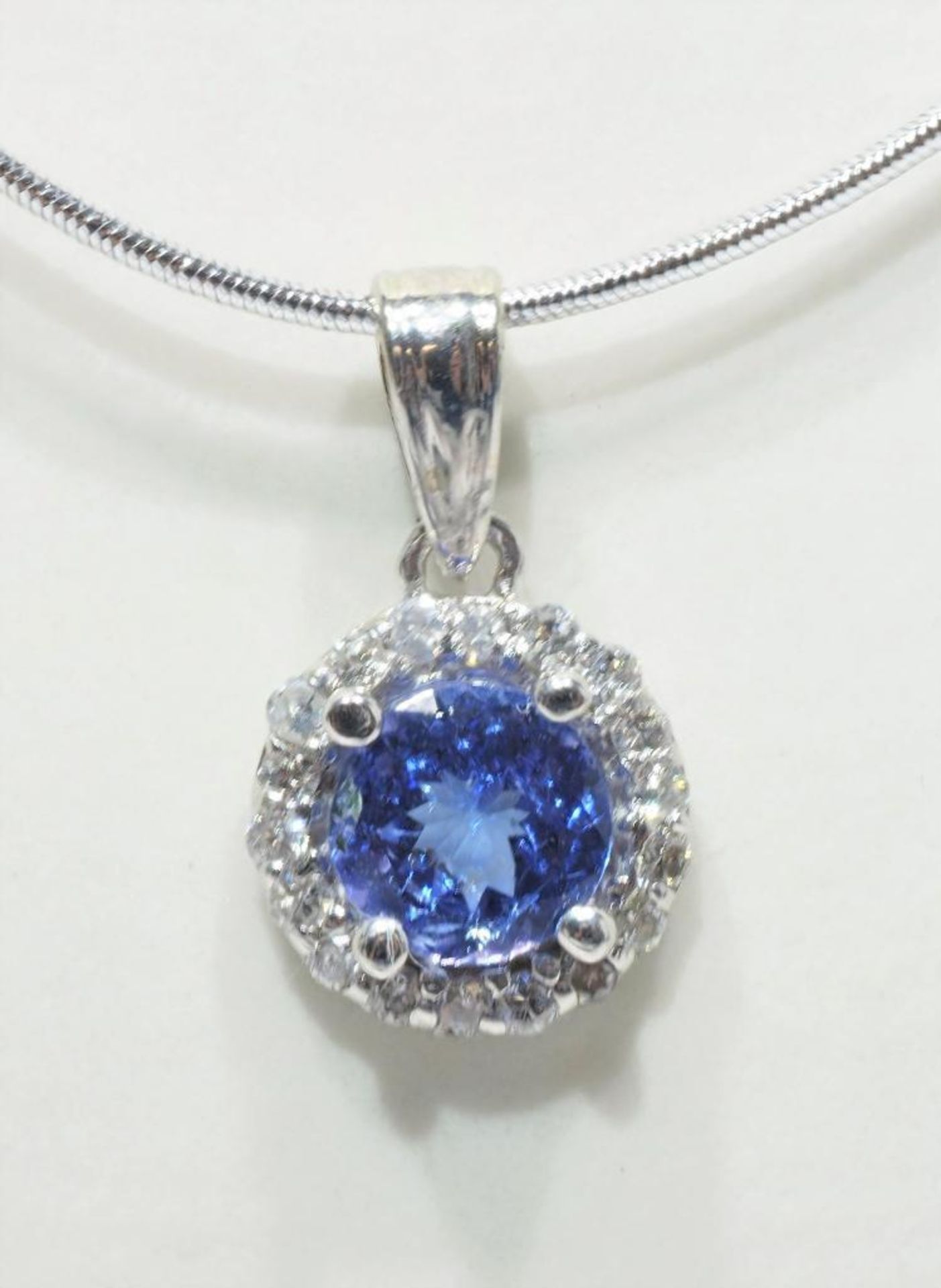 14K White Gold Tanzanite and Diamond Pendant with Japanese steel wire neckpiece. Retail $1800