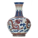 A Chinese cobalt blue underglazed and copperred glazed dragons amongst clouds decorated vase with