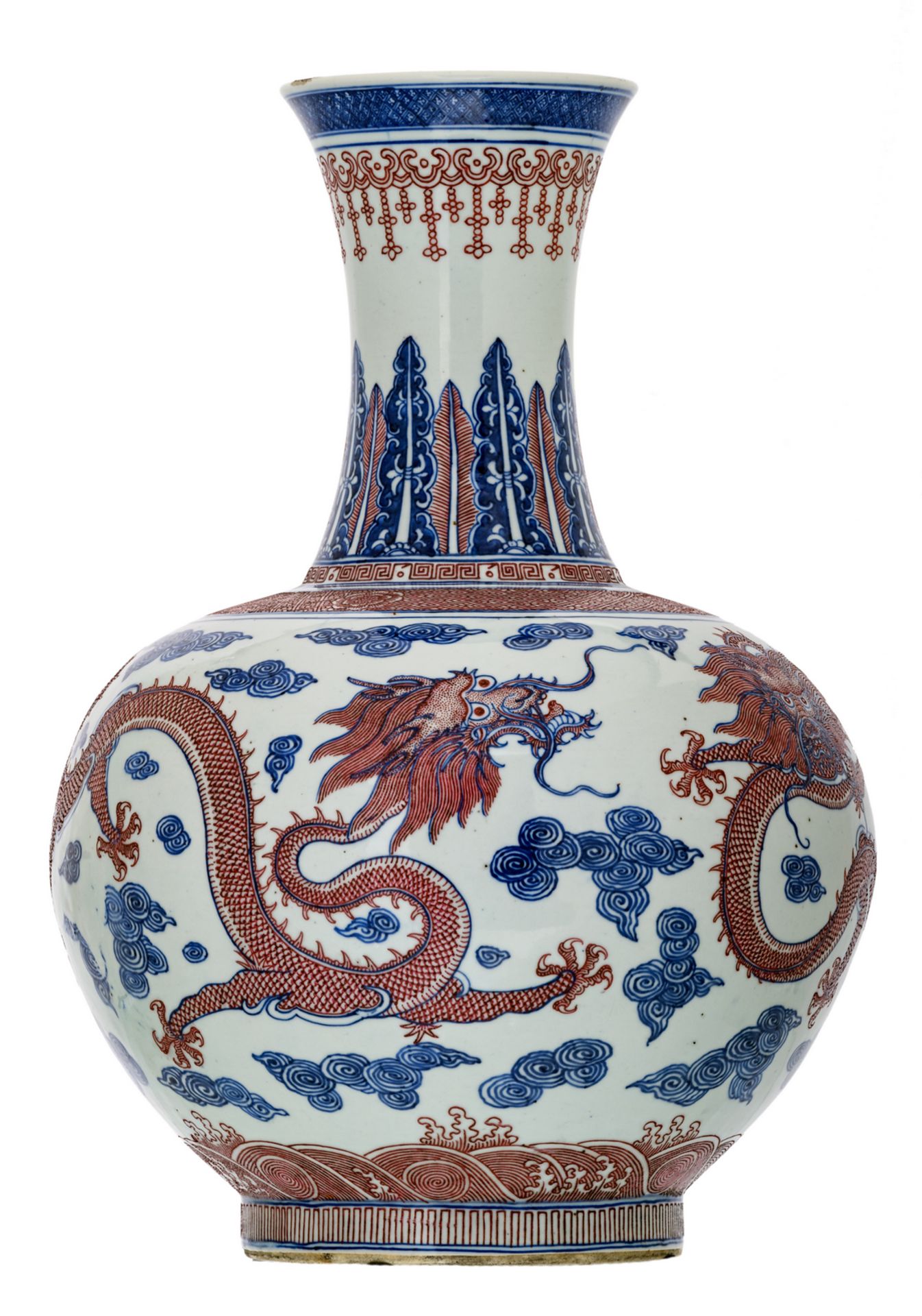 A Chinese cobalt blue underglazed and copperred glazed dragons amongst clouds decorated vase with