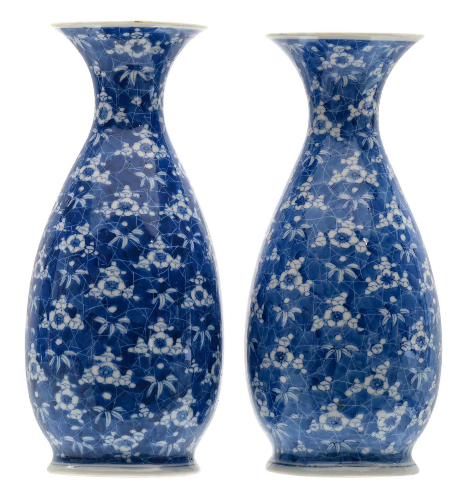 Two Japanese blue and white floral decorated vases, marked, Meiji and period, H 26 cm