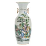 A Chinese polychrome decorated vase with figures in a mountainous landscape and calligraphic