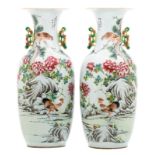 A pair of Chinese famille rose and polychrome decorated vases, one side with a rooster, a bird of