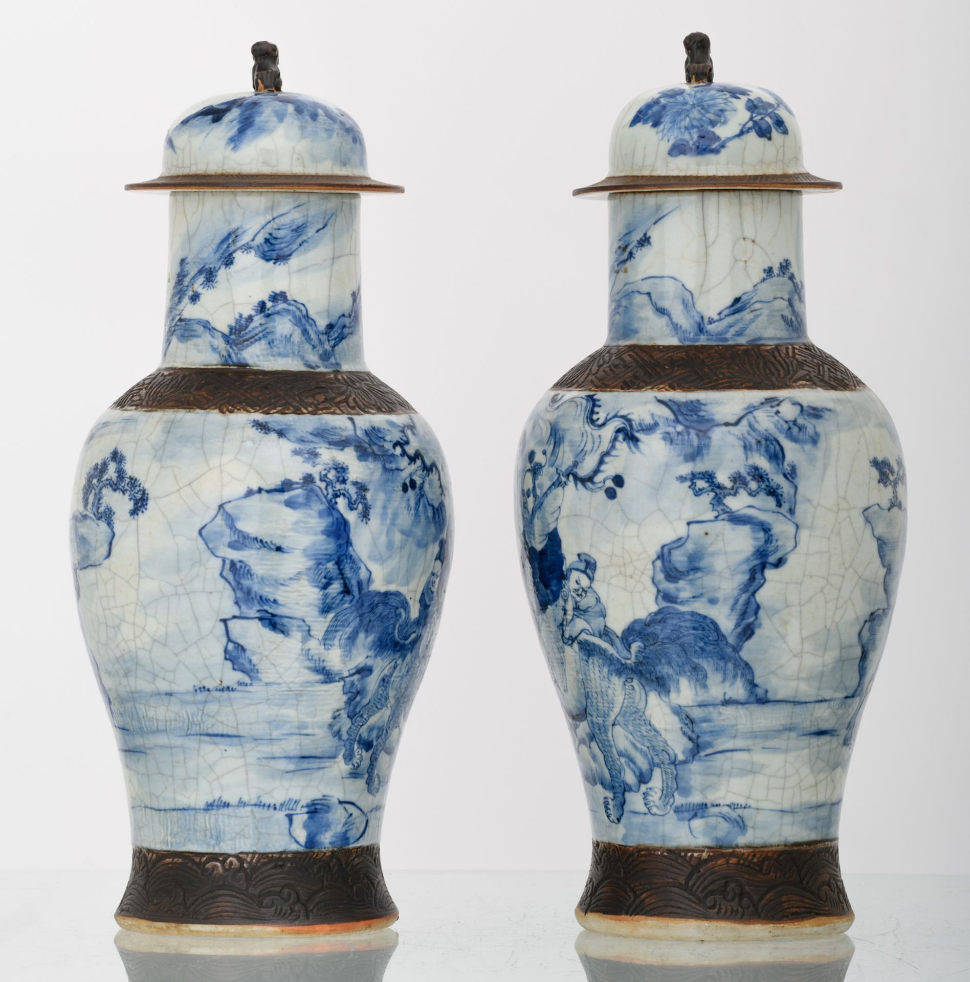 Two Chinese stoneware blue and white decorated crackleware vases and covers with deities in a - Image 2 of 6