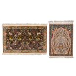 Two Oriental carpets, wool and silk on cotton, decorated with floral motifs and various animals,