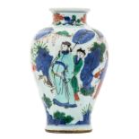 A Chinese overall polychrome decorated vase with figures in a rock garden, H 19 cm