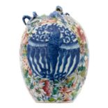 A Chinese millefleurs ground blue and white relief decorated vase with a dragon and a bat, the