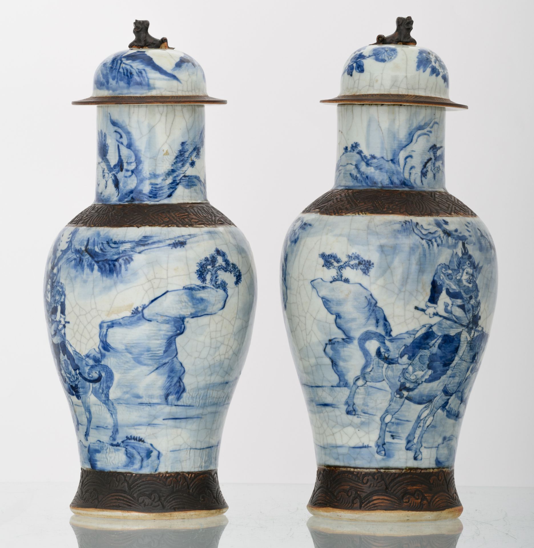 Two Chinese stoneware blue and white decorated crackleware vases and covers with deities in a - Image 3 of 6