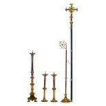 Three brass candlesticks, one clothes hanger and a processional cross, H 73,5 - 235,5 cm