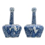 A pair of Chinese blue and white floral and relief decorated tulip vases, the roundels with