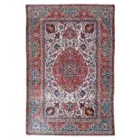 A fine Persian rug, wool and silk on cotton, decorated with floral motifs and a central medallion,