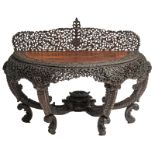 An Oriental open work and richly carved exotic hardwood side table with floral motifs, H 108 - W 146