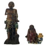 Two Japanese polychrome glazed stoneware figures depicting monks, about 1900, H 18,5 - 41 cm