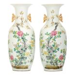 A pair of Chinese famille rose decorated vases with flower branches on a rock and bats, marked, H 58