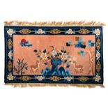 A Chinese carpet decorated with a crane and deer in a landscape, wool on cotton, 80 x 138 cm