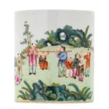 A Chinese famille rose brushpot, overall decorated with boys playing in a garden, with a Qianlong