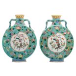 Two Chinese turquoise ground famille rose floral decorated moon flasks, the roundels with auspicious