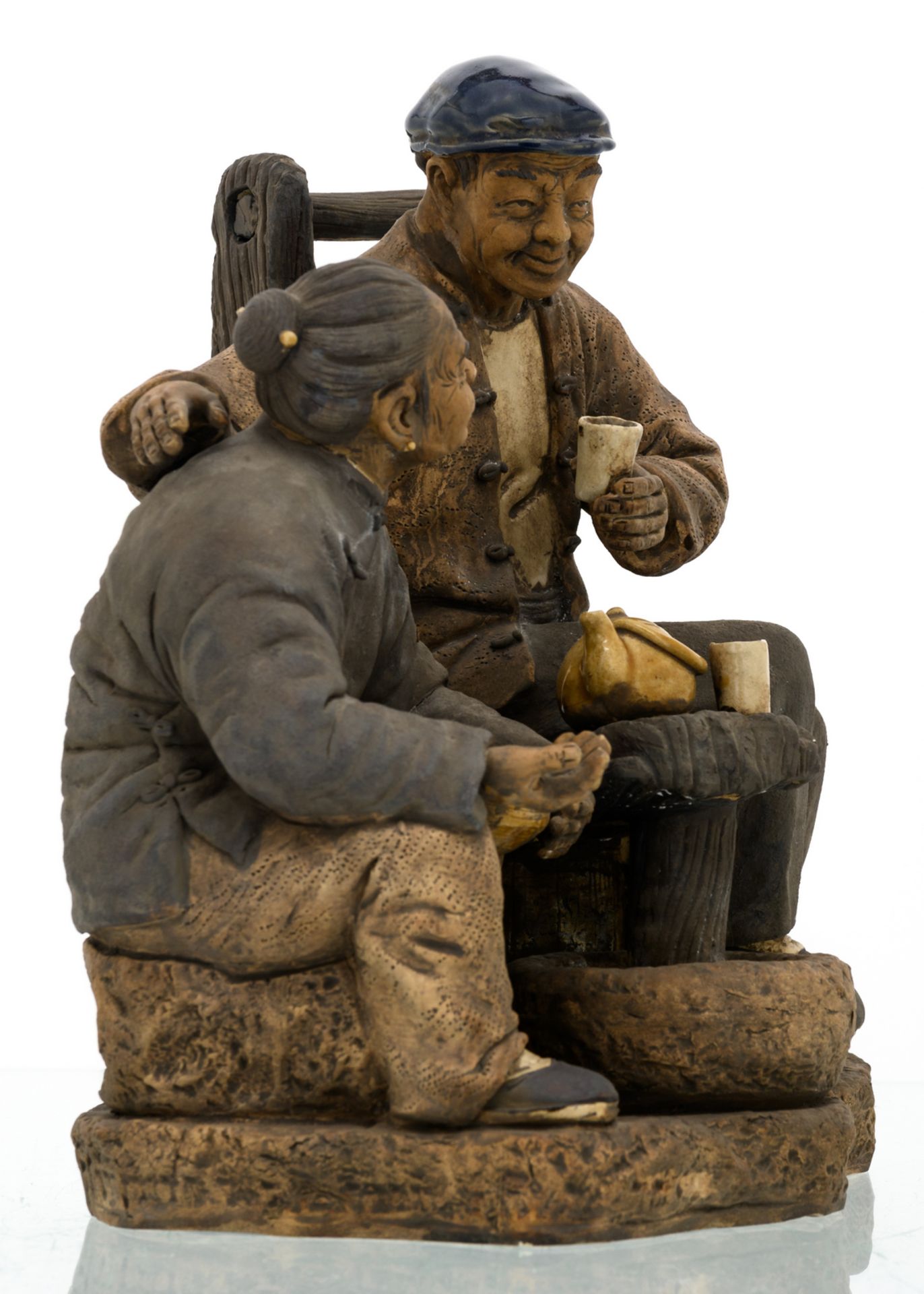 A Chinese polychrome stoneware partially glazed group depicting a seated peasant and his wife, - Image 5 of 8