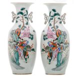 A pair of Chinese famille rose decorated vases with figures in a cortege and calligraphic texts, H