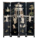 A Chinese polychrome decorated black lacquered four panel screen with mother-of-pearl, bone, ivory