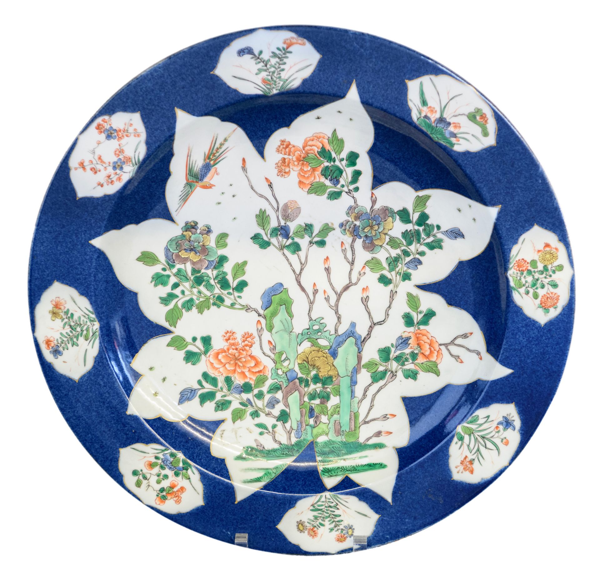 A Chinese blue poudré ground plate, the roundels famille verte decorated with a rock, flower