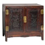 A Chinese carved two doors buffet with brass mounts, the panels with flower branches, about 1900,