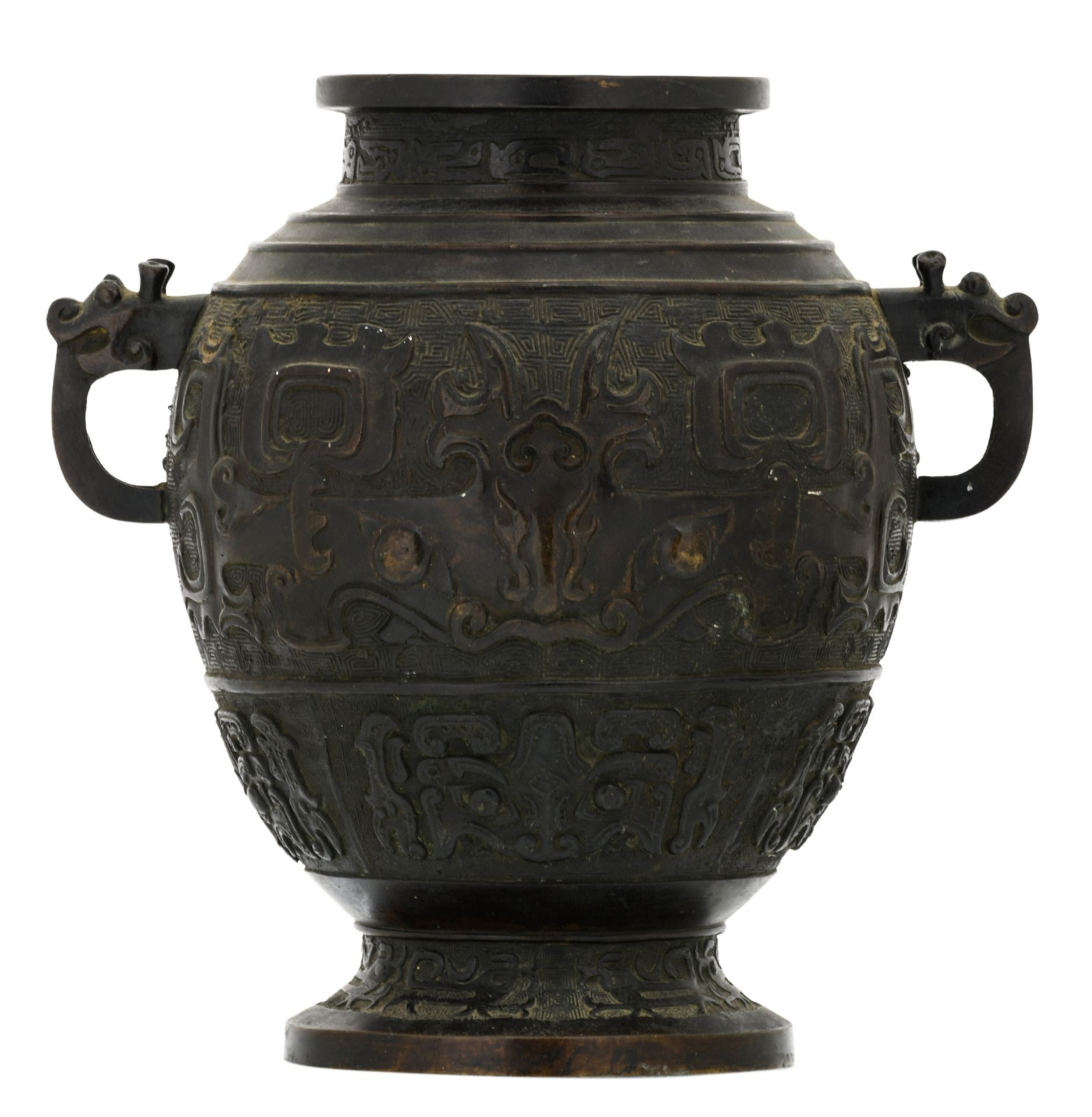 A Chinese bronze archaic vessel, relief decorated with taoti, the handles dragon shaped, about 1900,